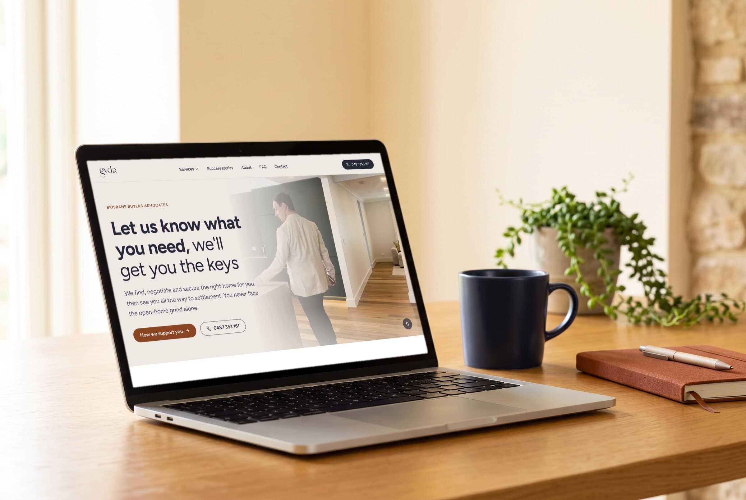 The gyda home page on a laptop on an oak desk